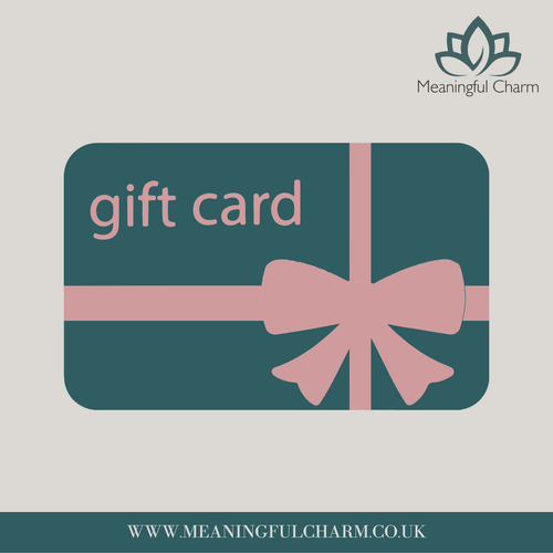 A stylized gift card graphic with rounded corners, dark teal background, pink ribbon and bow, and the words 'gift card' in pink. The Meaningful Charm logo appears in the top right, and the website 'WWW.
