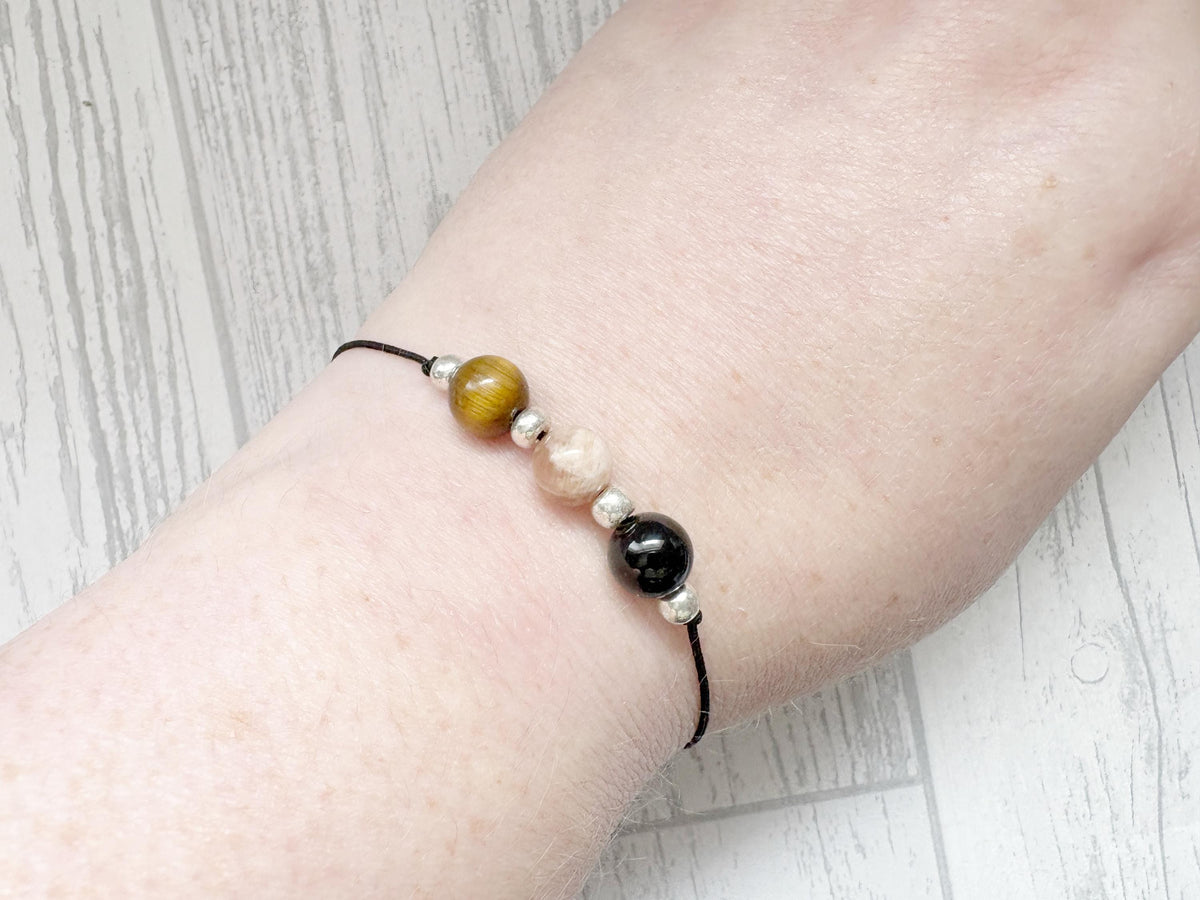 Beaded bracelet on a wrist with a light wooden background